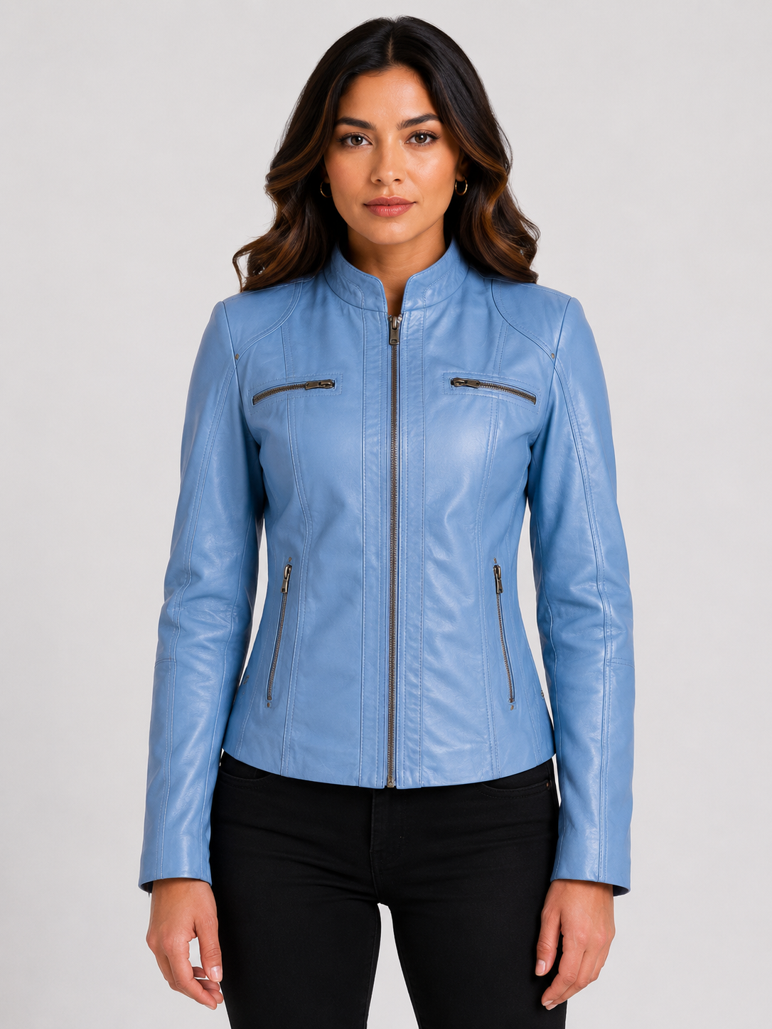 Woman wearing a blue leather biker jacket showing the fitted silhouette and proper leather jacket sizing