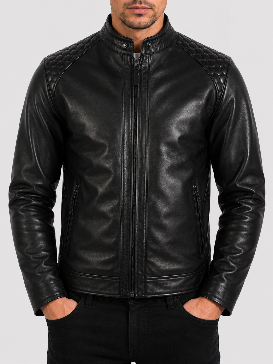 Man wearing a black textured leather biker jacket showing the pronounced natural grain of the leather