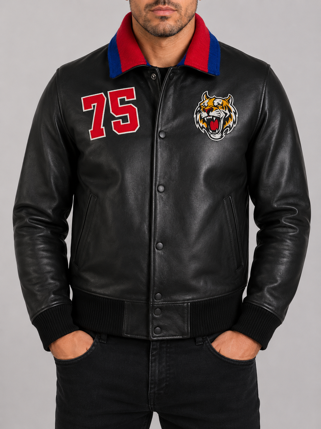 Man wearing an Alder & Stone black leather varsity jacket with tiger patch and ribbed collar